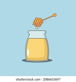 Glass jar with honey and a spoon