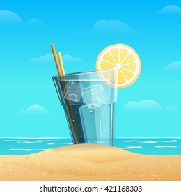 Glass with lemonad with slice oflemon on sea background. Cold drink with ice cube on the sand.