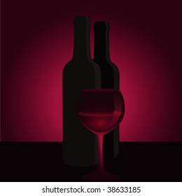 Glass of red wine with bottle.