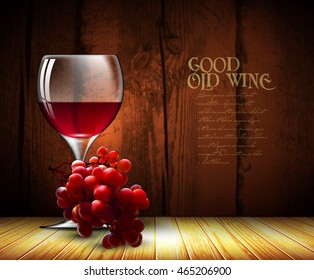 glass of red wine and a branch of grapes