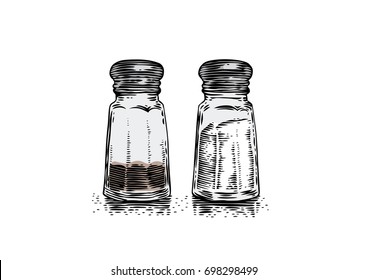 Glass salt shaker and peppermill on the white background