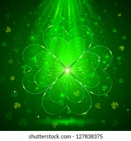 Glass shining clover in the green magic light