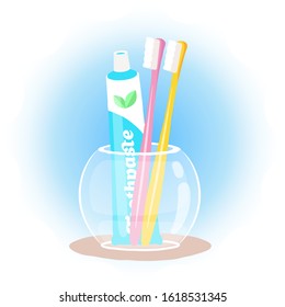 A glass with toothbrushes and a tube of toothpaste.