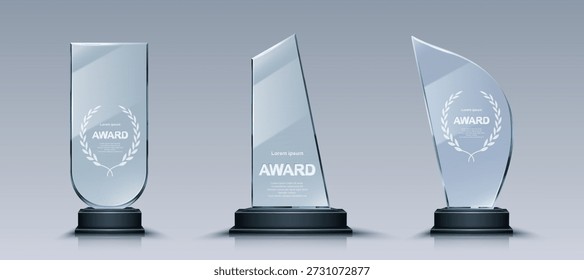 Glass trophy set with elegant laurel wreath engravings on crystal plates. Transparent award collection with unique glass shapes on dark pedestals designs for business or sport recognition ceremonies.