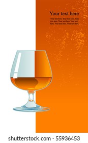 Glass of whiskey on orange background.