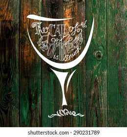 Glass of wine against the wooden peeling background with hand drown inscription. Philosophy poster.
