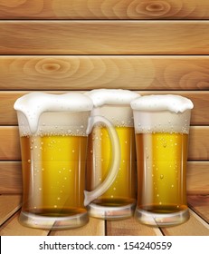 glasses of beer and a wooden background