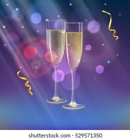 Glasses of champagne and streamer with rays of light on background. Champagne with bubbles in a wineglass with place for your text