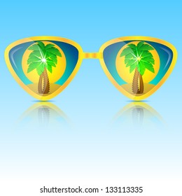 glasses of yellow with the reflection of palms and sun