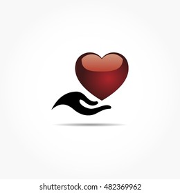 glassy maroon red love shape on a black woman hand with drop shadow