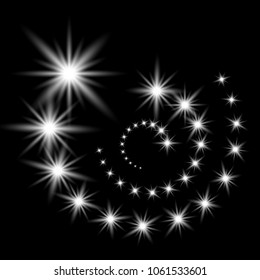 Glittering flying stars with star dust, glowing stars on black background, light effect, white color