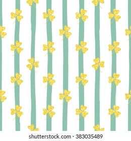 Glittering gold clover seamless pattern on striped background. Seamless background for greeting card for St. Patrick's day. Recurring pattern of clove flower -  sign of the St. Patrick's day. eps