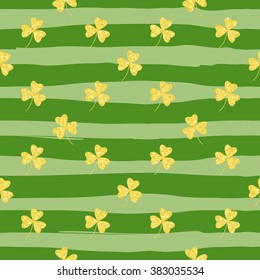 Glittering gold clover seamless pattern on striped background. Seamless background for greeting card for St. Patrick's day. Recurring pattern of clove flower -  sign of the St. Patrick's day. eps