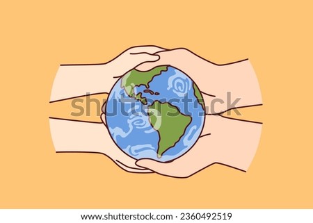 Globe in hands of two people caring about planet earth and wishing to save nature from pollution and climate change. Miniature globe to advertise environmental initiatives to reduce co2 emissions