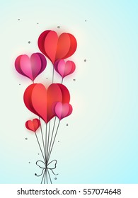 Glossy beautiful paper Hearts binding by ribbon for Happy Valentine's Day Celebration.