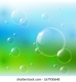 Glossy bubbles on nature background