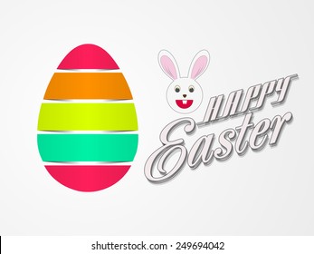 Glossy colorful egg with cute smiling bunny on grey background for Happy Easter celebration.