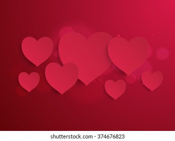 Glossy elegant paper hearts on shiny red background for Happy Valentine's Day celebration.