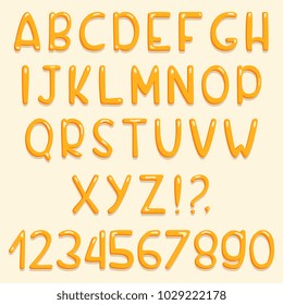 Glossy font design. Yellow ABC letters and numbers. Vector set of cartoon letters