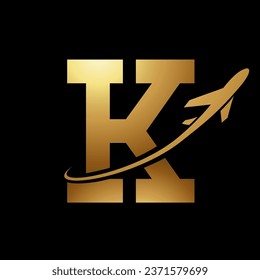 Glossy Gold Antique Letter K Icon with an Airplane on a Black Background