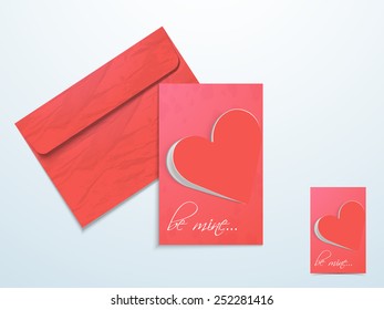Glossy love greeting card with red flip heart, text Be Mine and envelope.