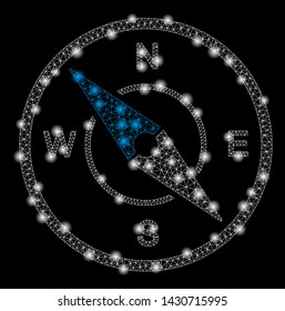 Glossy mesh compass with sparkle effect. Abstract illuminated model of compass icon. Shiny wire frame triangular mesh compass. Vector abstraction on a black background.