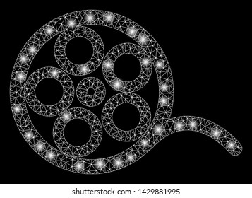 Glossy mesh film roll with glare effect. Abstract illuminated model of film roll icon. Shiny wire carcass triangular mesh film roll. Vector abstraction on a black background.