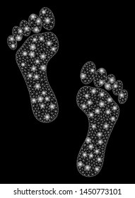Glossy mesh footprints with glow effect. Abstract illuminated model of footprints icon. Shiny wire carcass polygonal network footprints. Vector abstraction on a black background.