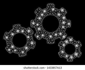 Glossy mesh gears with glare effect. Abstract illuminated model of gears icon. Shiny wire frame polygonal mesh gears. Vector abstraction on a black background.