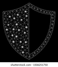 Glossy mesh shield with glitter effect. Abstract illuminated model of shield icon. Shiny wire carcass triangular network shield. Vector abstraction on a black background.