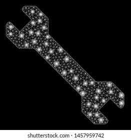 Glossy mesh wrench with glare effect. Abstract illuminated model of wrench icon. Shiny wire frame polygonal network wrench. Vector abstraction on a black background.