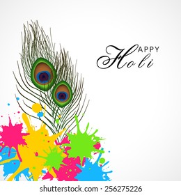 Glossy peacock feather with colorful splash on white background for Indian Festival, Holi celebration.