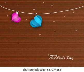 Glossy pink and blue Hearts hanging on beautiful wooden background for Happy Valentine's Day Celebration.