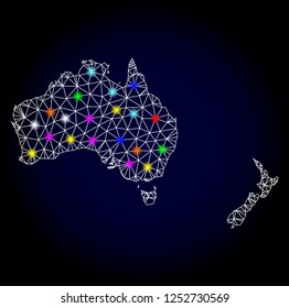 Glossy polygonal mesh map of Australia and New Zealand with glow effect. Vector carcass map of Australia and New Zealand with glowing colorful points for New Year illustrations. White mesh lines.