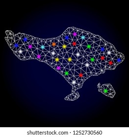 Glossy polygonal mesh map of Bali Island with glow effect. Vector carcass map of Bali Island with glowing multicolored points for New Year purposes. White mesh lines. Dark blue background.