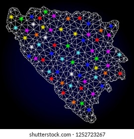 Glossy polygonal mesh map of Bosnia and Herzegovina with glow effect. Vector carcass map of Bosnia and Herzegovina with glowing multi colored dots for Christmas purposes. White mesh lines.