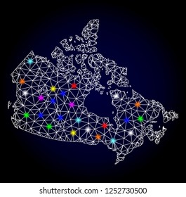 Glossy polygonal mesh map of Canada with glare effect. Vector carcass map of Canada with glowing multi colored dots for Christmas posters. White mesh lines. Dark blue background. Constellation effect.