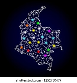 Glossy polygonal mesh map of Colombia with glow effect. Vector carcass map of Colombia with glowing multi colored points for New Year purposes. White mesh lines. Dark blue background.
