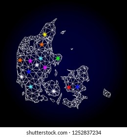 Glossy polygonal mesh map of Denmark with glare effect. Vector carcass map of Denmark with glowing colorful spheres for New Year templates. White mesh lines. Dark blue background.