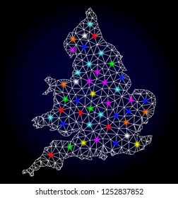 Glossy polygonal mesh map of England with glare effect. Vector carcass map of England with glowing multicolored points for New Year posters. White mesh lines. Dark blue background.