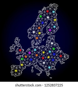 Glossy polygonal mesh map of Euro Union with glow effect. Vector carcass map of Euro Union with glowing multi colored dots for New Year illustrations. White mesh lines. Dark blue background.