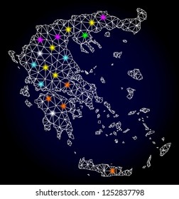 Glossy polygonal mesh map of Greece with glare effect. Vector carcass map of Greece with glowing multi colored spheres for New Year templates. White mesh lines. Dark blue background.