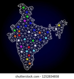 Glossy polygonal mesh map of India with glare effect. Vector carcass map of India with glowing multi colored dots for Christmas purposes. White mesh lines. Dark blue background. Constellation effect.