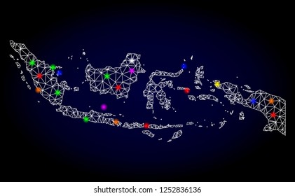 Glossy polygonal mesh map of Indonesia with glare effect. Vector carcass map of Indonesia with glowing multicolored points for Christmas illustrations. White mesh lines. Dark blue background.