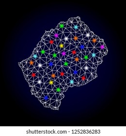 Glossy polygonal mesh map of Lesotho with glow effect. Vector carcass map of Lesotho with glowing multi colored spheres for Christmas posters. White mesh lines. Dark blue background.