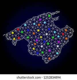 Glossy polygonal mesh map of Majorca with glare effect. Vector carcass map of Majorca with glowing multi colored spheres for Christmas purposes. White mesh lines. Dark blue background.
