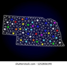 Glossy polygonal mesh map of Nebraska State with glare effect. Vector carcass map of Nebraska State with glowing multi colored spheres for New Year templates. White mesh lines. Dark blue background.