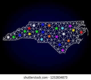 Glossy polygonal mesh map of North Carolina State with glare effect. Vector carcass map of North Carolina State with glowing multi colored points for Christmas illustrations. White mesh lines.