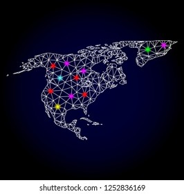 Glossy polygonal mesh map of North America and Greenland with glow effect. Vector carcass map of North America and Greenland with glowing multi colored points for Christmas purposes. White mesh lines.