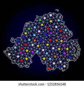 Glossy polygonal mesh map of Northern Ireland with glow effect. Vector carcass map of Northern Ireland with glowing multicolored points for New Year illustrations. White mesh lines.